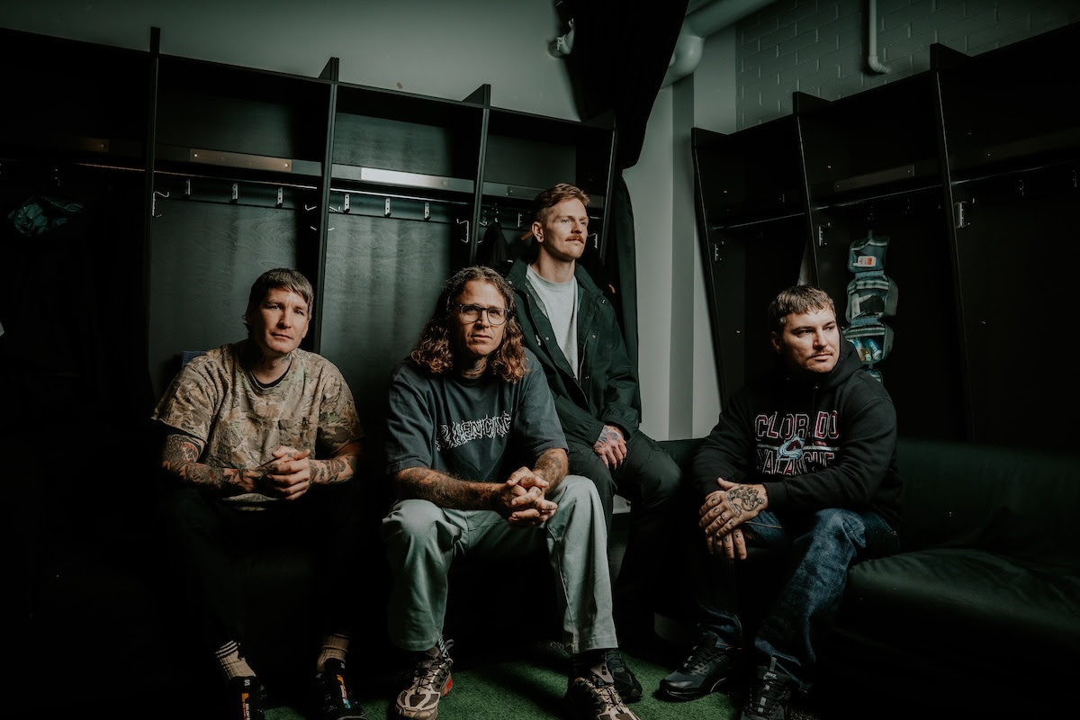 The Amity Affliction seated together in a backstage portrait.