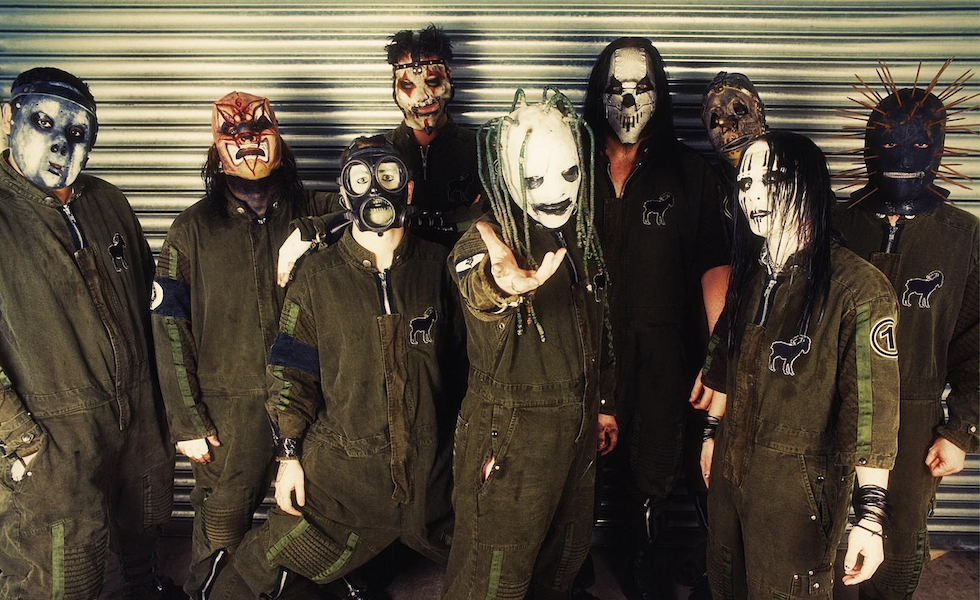 Slipknot pose in masks and dark coveralls in an archival group photograph.