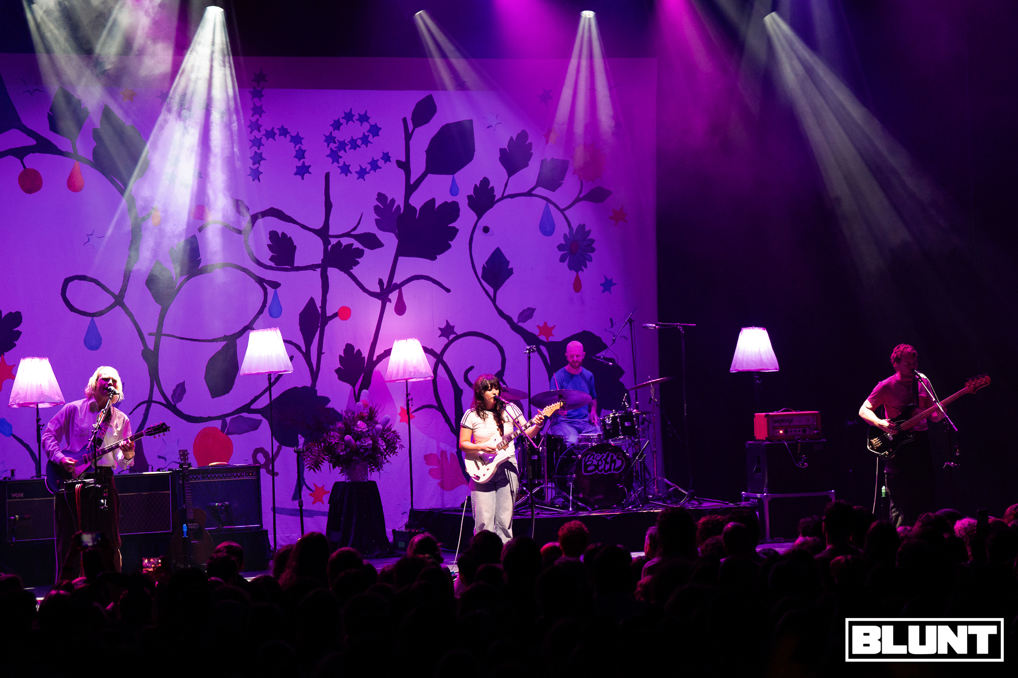 The Beths perform beneath violet stage lights at Melbourne’s Forum Theatre.